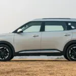 Kia Carens Clavis side view with alloy wheels and roof rails