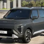 Kia Syros HTK EX front profile parked on road showcasing LED DRLs and alloy wheels