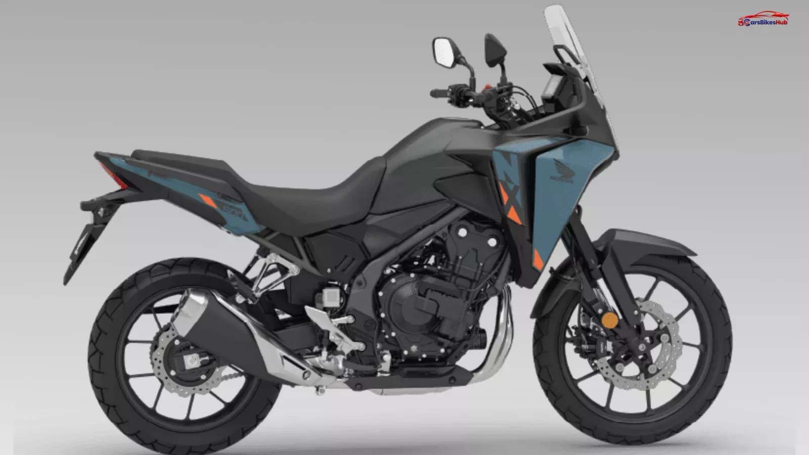 Honda NX500 E-Clutch adventure motorcycle parked on mountain road with touring setup