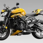 Triumph Street Triple 765 sport bike parked on a mountain road showcasing aggressive styling and premium naked motorcycle design