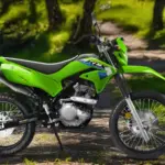 Kawasaki KLX230 S dual-sport motorcycle parked on a trail, highlighting its lower seat height and adventure-ready design.