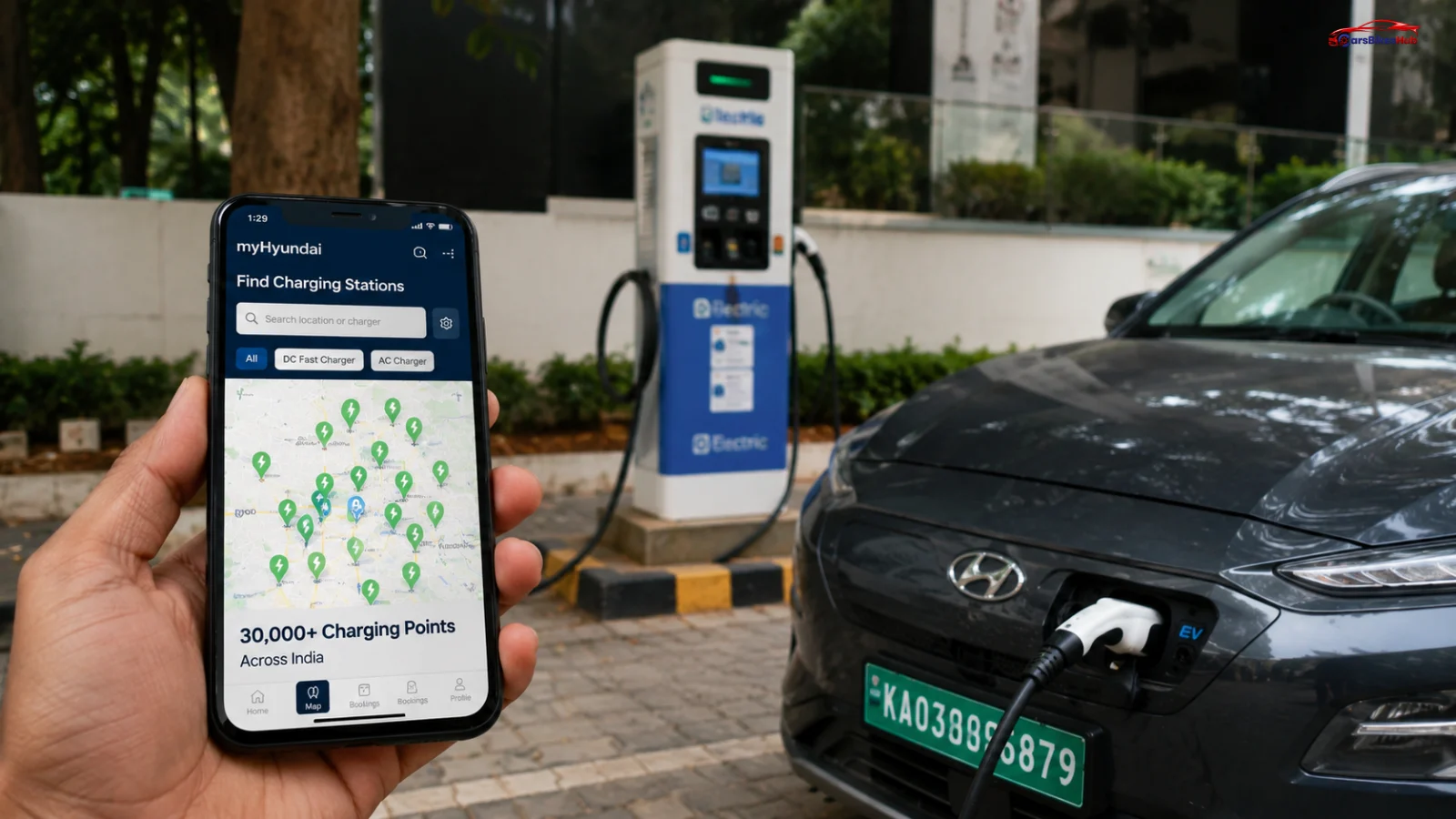 A smartphone displaying the myHyundai app beside a Hyundai electric vehicle charging at a public EV charging station in India.