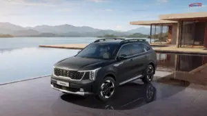 Kia Sorento SUV parked beside a scenic lake with mountains in the background