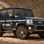 2026 Mahindra Bolero Bold Edition in black with bronze exterior accents, bronze alloy wheels and roof rails.