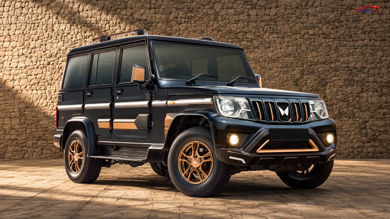 2026 Mahindra Bolero Bold Edition in black with bronze exterior accents, bronze alloy wheels and roof rails.